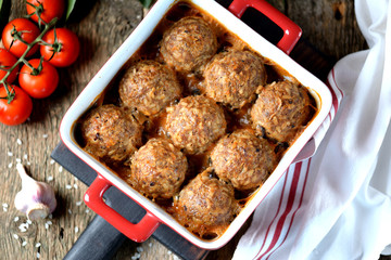 Beef meat balls with rice baked in tomato sauce.