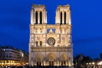 Notre-Dame de Paris Cathedral facade at dusk with illuminations