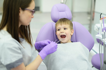 A little boys first check up. Kid visits the dentists office for the first time
