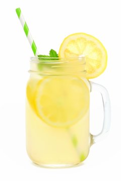 Mason jar glass of lemonade with straw isolated on a white background