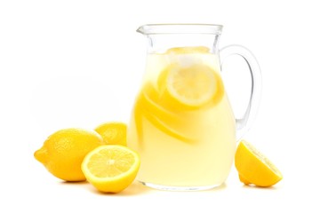 Pitcher of lemonade with lemons isolated on a white background