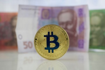 Gold bitcoin coin and Ukraine money