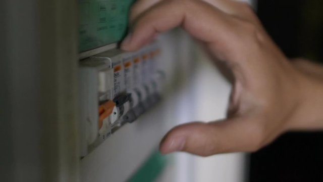 Man launched emergency generator and turning on toggle switches to spread light