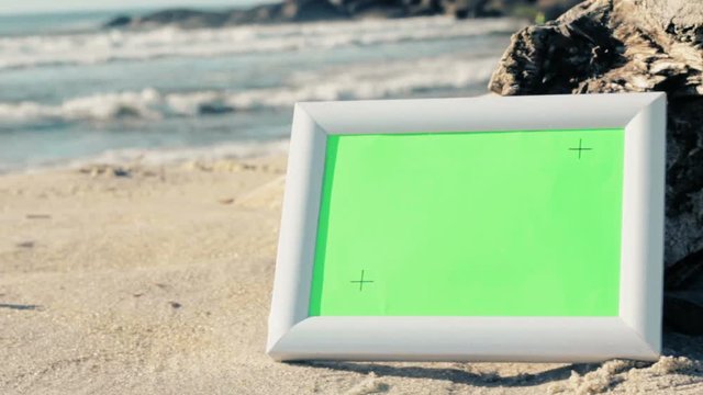 White photo frames with green screen and tracking points, for advertising copy space of photos/videos, on a summer beach scene background. 