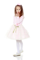 Naklejka premium Elegant little girl in a pink dress.