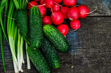 Radish cucumbers and green onion on wooden table. Top view