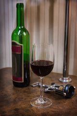 bottle, glass of wine and corkscrew