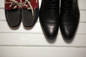 Pairs of new shoes on wooden plank