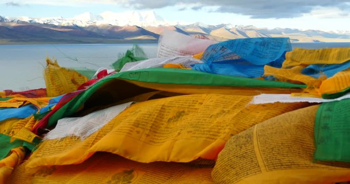 4k huge clouds mass rolling over lake namtso & Tanggula snow mountain peak,tibet mansarovar,pray flag in wind,Tibet's second largest lake,is the third largest saltwater lake in China.