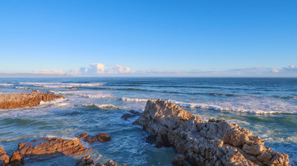 Rocks at Sea with Waves and Clouds