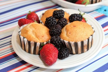Fresh baked muffins with blueberries and strawberries
