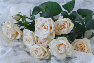 White roses on a old white wooden table