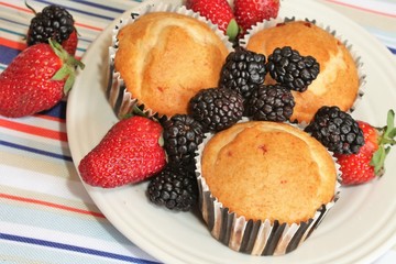 Fresh baked muffins with blueberries and strawberries