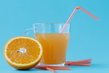 Glass of orange juice and fresh oranges