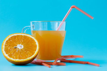 Glass of orange juice and fresh oranges