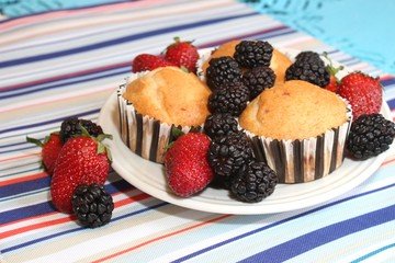 Fresh baked muffins with blueberries and strawberries