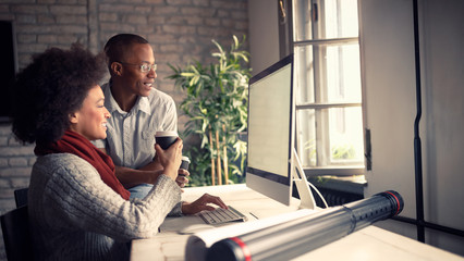 Employees in architect office working on computer