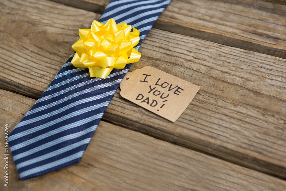 Wall mural high angle view of necktie with greetings on table