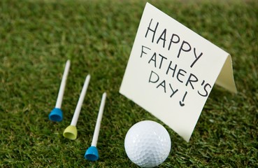happy fathers day text by golf ball and tees  - Powered by Adobe