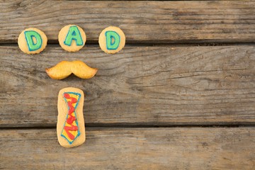 Overhead view of text decoration on cookies at table