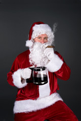 Fototapeta na wymiar Santa Claus smoking a cigar and drinking coffee