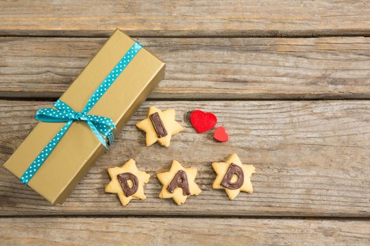 Overhead view of gift box by coockies with text obn table