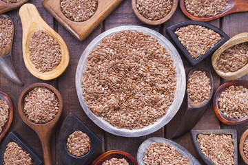 Flax seeds in wooden bowl and spoon