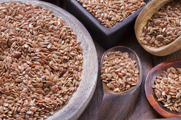Flax seeds in wooden bowl and spoon