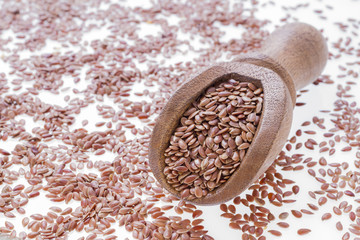 Flax seeds in wooden bowl and spoon