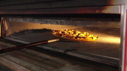 Cooked Pizza on a special shovel comes from the oven