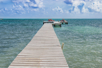 Fototapeta premium Wooden pier dock and ocean view at Caye Caulker Belize Caribbean.