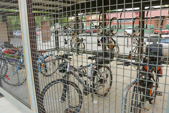 Fototapeta bicycles in a locker or cage at a railway station