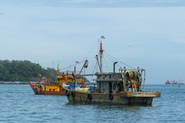Fisherman boats anchored at Kota Kinabalu (KK). KK is a major city with unquestionably some of the best beaches on the Borneo island. - obrazy, fototapety, plakaty