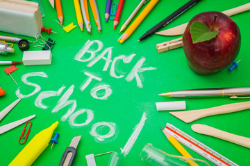 School supplies on Green chalkboard " Back to school background " .