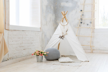 Children's hut in the room. Wigwam for kids in rustic style. Children room in loft or rustic style © Olga Mishyna