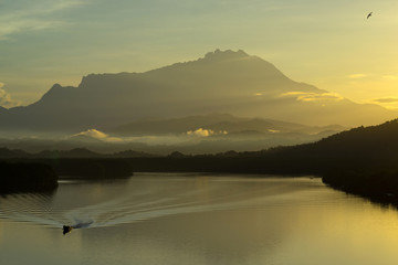 Beautiful sunrise over Mount Kinabalu and river Ganyang in Sabah, Malaysia. View point from Mengkabong bridge