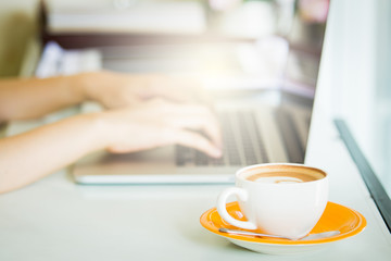 Cup of coffee and smart devices on the table close up.