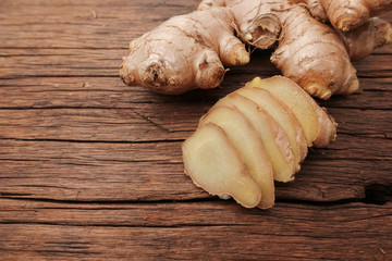 Ginger root sliced on wooden table