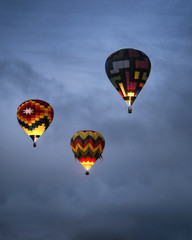 Three Hot Air Balloons at Dawn in the Clouds