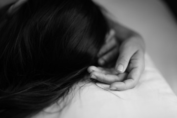 woman sit on a bed in a bedroom - concept photo of Sexual assault