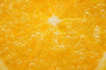 Sliced orange fruit with bubbles