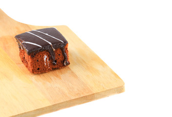 .chocolate cake pour cream on cutting board  isolated  white background and clipping path. select focus with shallow depth of field