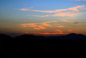 sunset in sky and cloud, beautiful colorful twilight time with mountain silhouette