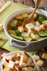 Bread soup with summer vegetables close-up in a bowl. vertical