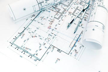 architects workplace with project plans of house arrangement and drawing compass