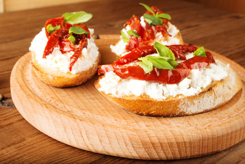 Italian sandwiches - bruschetta with cheese, tomato and basil