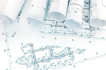 engineering and architectural drawings with rolls of blueprints