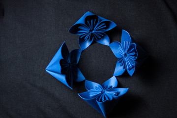 Origami flower on black background