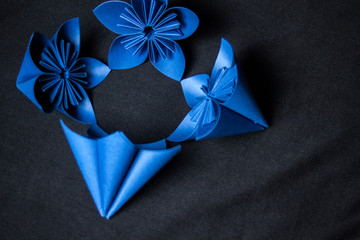 Origami flower on black background