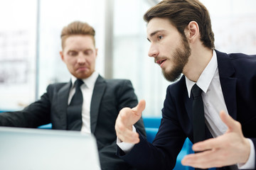 Salesman explaining his idea of overcoming crisis to co-worker